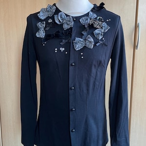 Vintage woman&#39;s jacket Pierre Cardin black colour made in viscose and elastane with bows and rhinestones.