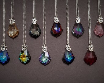May include: Ten silver necklaces with teardrop-shaped crystal pendants in various colors, including clear, blue, green, red, and pink.