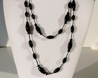 Long black stone necklace with faceted onyx stones hand knotted on black silk cord. A very long elegant necklace