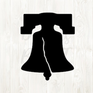 May include: A black silhouette of the Liberty Bell, a symbol of American independence. The bell is depicted with its iconic crack, set against a white wood grain background. The design is simple and bold.