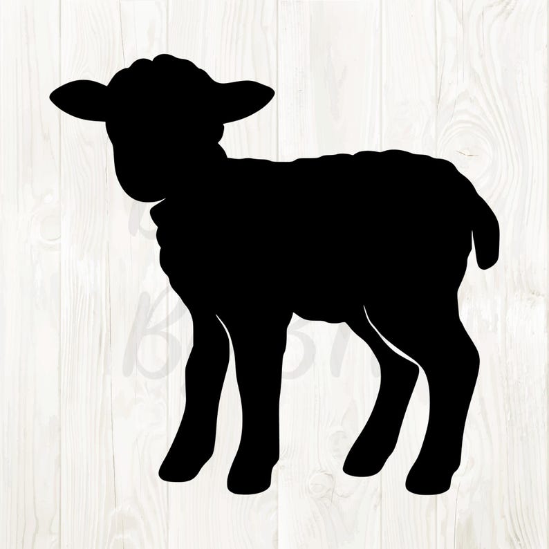 May include: A black silhouette of a lamb standing on four legs. The lamb has a rounded body, small ears, and a fluffy appearance. The background is a light wood grain pattern.