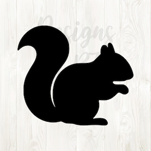 May include: A black silhouette of a squirrel in a sitting position. The squirrel has a large, bushy tail that curves upwards. The image is set against a white wooden background.
