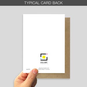 A typical card back with a brown envelope is held. The card features stu art concepts logo which is a black square and coloured accents. The card's back has the text "STU ART CONCEPTS" and a website address.