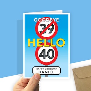A personalised 40th birthday card with a light blue gradient background featuring road-sign style graphics. At the top, a red-bordered circle with a diagonal line through the number 39 is labeled "GOODBYE" above it. In the centre, the word "HELLO" is written in large yellow text, followed by a second red-bordered circle containing the number 40. At the bottom, a white rectangular sign with rounded corners reads "HAPPY BIRTHDAY your recipient's name."