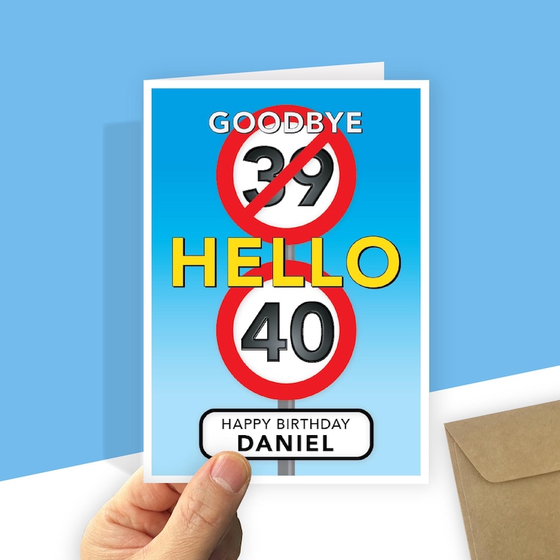 A personalised 40th birthday card with a light blue gradient background featuring road-sign style graphics. At the top, a red-bordered circle with a diagonal line through the number 39 is labeled "GOODBYE" above it. In the centre, the word "HELLO" is written in large yellow text, followed by a second red-bordered circle containing the number 40. At the bottom, a white rectangular sign with rounded corners reads "HAPPY BIRTHDAY your recipient's name."