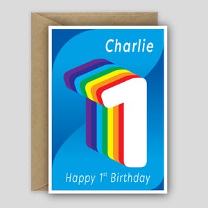 May include: A greeting card with a blue background featuring a large white number one with a rainbow-colored layered effect. The text Charlie is printed at the top and Happy 1st Birthday is printed at the bottom in white sans-serif font.