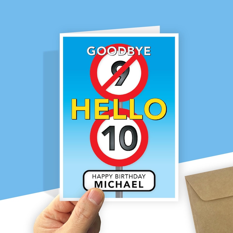 A personalised 10th birthday card with a light blue gradient background featuring road-sign style graphics. At the top, a red-bordered circle with a diagonal line through the number 9 is labeled "GOODBYE" above it. In the centre, the word "HELLO" is written in large yellow text, followed by a second red-bordered circle containing the number 10. At the bottom, a white rectangular sign with rounded corners reads "HAPPY BIRTHDAY your recipient's name."