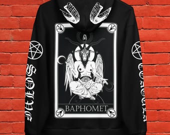 May include: Black hooded sweatshirt featuring a white graphic of Baphomet, a goat-headed deity, within a framed design. The sleeves display white text and pentagrams. The hood has a white wing design.