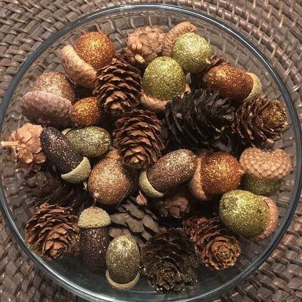 Set of golds, brown, and orange glittered acorns with gold glittered and regular pine cones. Bowl or vase filler, or table accent for fall.