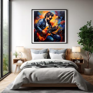 Puede incluir: Una pintura colorida de una persona tocando una guitarra eléctrica. La pintura está enmarcada en negro y está colgada en una pared blanca sobre una cama.
