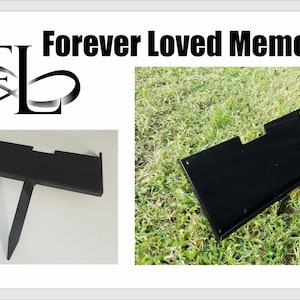 May include: Black metal memorial marker with a rectangular top and a stake for ground placement. The image includes the text "Forever Loved Memorials" and a logo. One marker is on grass, another on a white surface.