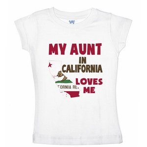 May include: White t-shirt with the text "My Aunt in California Loves Me" and a graphic of the California state flag.