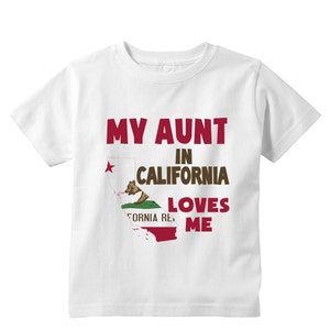 May include: White t-shirt with the text "My Aunt in California Loves Me" and a graphic of the California state flag.