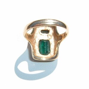 May include: A gold ring with a green emerald gemstone set in a rectangular shape.