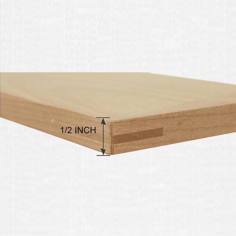 May include: A light brown wooden board with a smooth surface and a rectangular profile. The edge of the board features a horizontal slot running along its length. A measurement graphic indicates the thickness of the board is 1/2 inch.