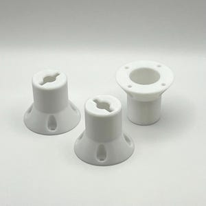 May include: Three white plastic parts with different shapes and sizes. The parts have a hole in the center and are designed to be used together.