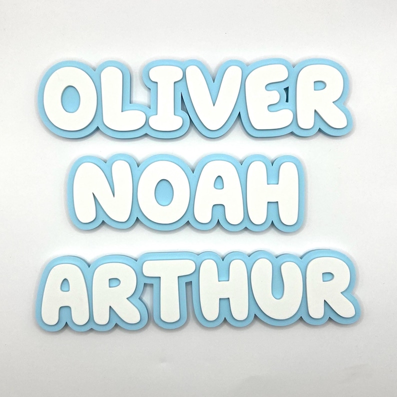 May include: Three blue and white foam letters spelling out the names "Oliver", "Noah", and "Arthur".