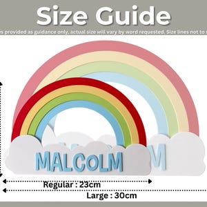 May include: A colorful rainbow-shaped wall decoration with the name "MALCOLM" in blue letters. The large size is 11.8 inches wide and 7.9 inches tall. The regular size is 9 inches wide and 5.9 inches tall. The text "Size Guide" is at the top.