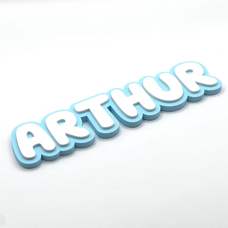 May include: A light blue and white 3D name sign that reads "ARTHUR".