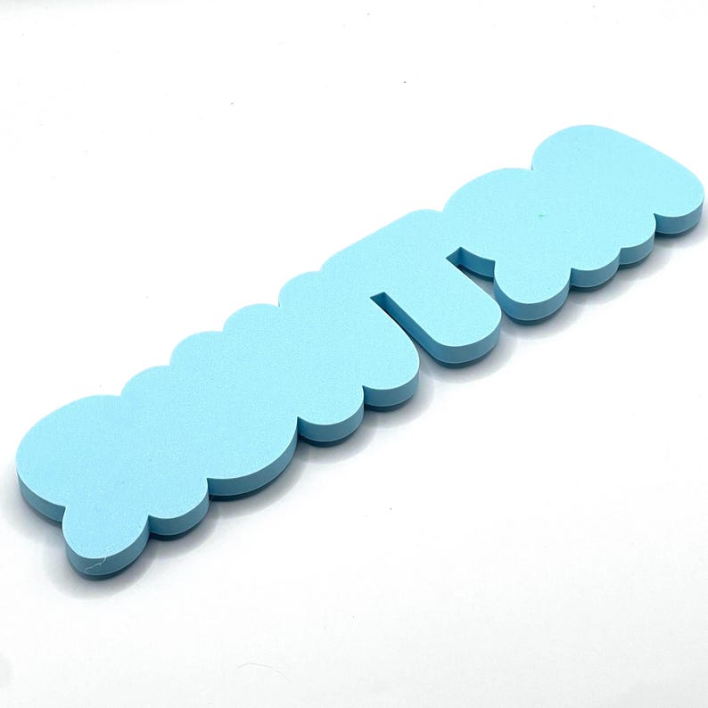 May include: Light blue foam letters spelling out the word "cutie".