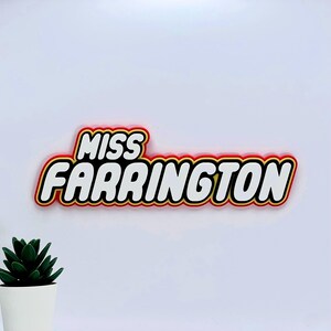 May include: A red, yellow, and black 3D sign with the text "MISS FARRINGTON" in white letters.
