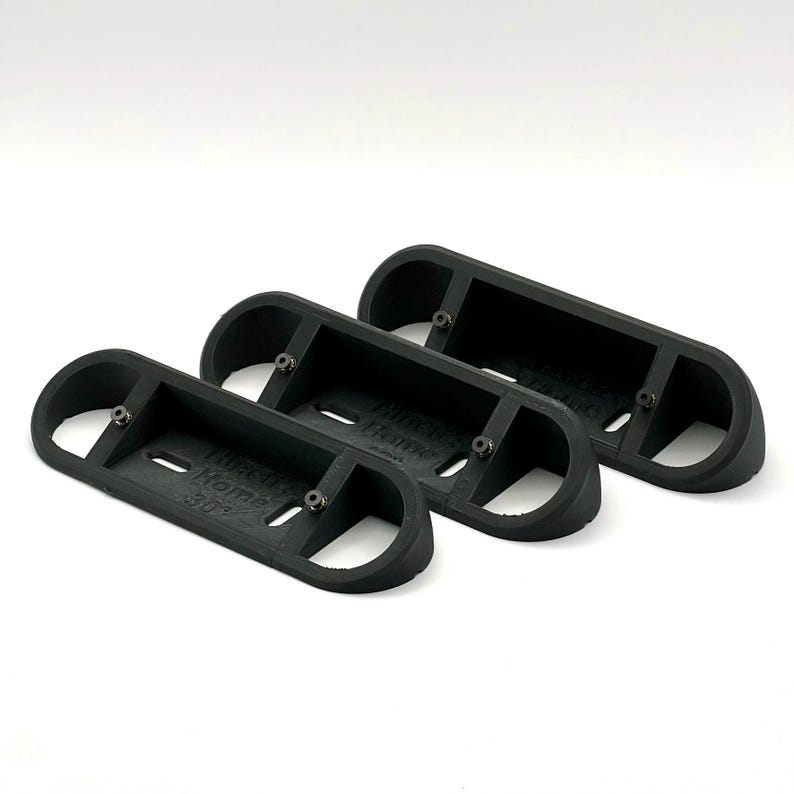 May include: Three black plastic wall mounts with the text "Think it Home" printed on them.