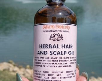 May include: A brown glass bottle with a gold lid and dropper. The bottle is labeled "Atura Beauty Herbal Hair and Scalp Oil" and contains 3.4 fl oz (100 ml) of oil. The label also states that the oil is infused with Ayurvedic herbs for hair and scalp health, rich in the fragrance of lavender essential oil, and enriched with essential vitamins and antioxidants.