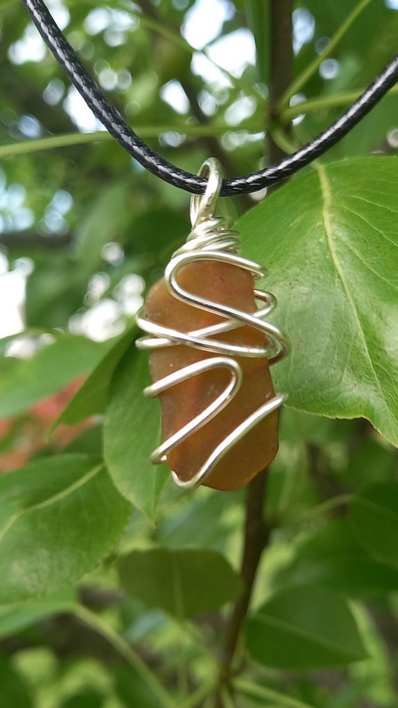Brown Wrapped Sea Glass Necklace designed using an 18-gauge silver tarnish-resistant wire with 20” length black waxed cotton cord.