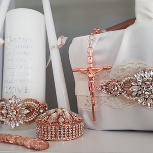 May include: A wedding unity candle set with a white candle decorated with the text "This day I will marry my friend the one I laugh with, live for, dream with love". The set also includes a rose gold ring bearer pillow, a rose gold ring box, and a rose gold rosary with a crucifix.