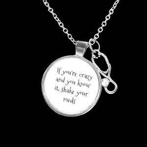 May include: Silver necklace with a round pendant that says "If you're crazy and you know it, shake your meds". The pendant is attached to a silver stethoscope charm.