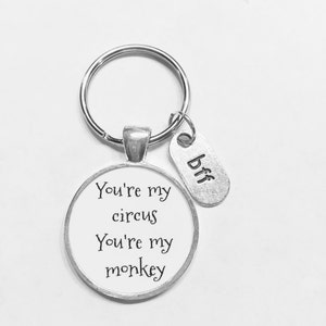 May include: Silver keychain with a round charm that says "You're my circus You're my monkey" and a smaller charm that says "bff".