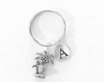 May include: Silver palm tree keyring with a silver letter A charm.