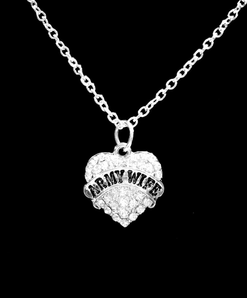 May include: Silver necklace with a heart-shaped pendant that says "Army Wife" in black lettering and is covered in clear rhinestones.