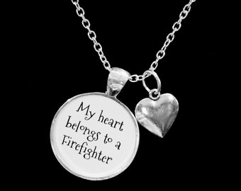 May include: Silver necklace with a round pendant that says "My heart belongs to a Firefighter" and a small heart charm.