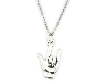 May include: Silver necklace with a pendant shaped like a hand making the sign for 'I love you' in American Sign Language.