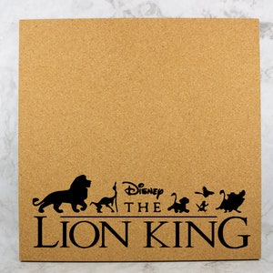 May include: A corkboard with a black silhouette of the Disney The Lion King characters, including Simba, Mufasa, and Nala. The text "Disney The Lion King" is printed below the characters.