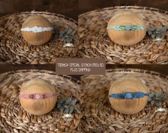 May include: Four floral tieback headbands displayed on wooden spheres. The white headband is labeled 'blanca', the sage green one 'saige', the dusty pink one 'rosie', and the blue one 'bluebell'. Each features small fabric flowers and leaves.