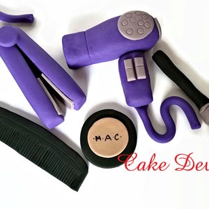 May include: Purple hair styling tools including a hairdryer, curling iron, comb, and makeup brush. A round compact with the text "M.A.C." is also included.