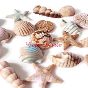 May include: Assortment of 15 decorative seashells and starfish in various colors and designs, including brown, white, pink, and blue. The seashells are made of a smooth, ceramic-like material and have a realistic appearance. The starfish are also made of a ceramic-like material and have a textured surface.