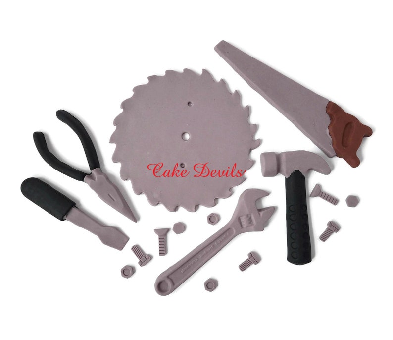 May include: A set of 10 fondant cake decorations shaped like tools, including a saw blade, a hammer, pliers, a wrench, a screwdriver, and nuts and bolts. The tools are all gray, black, and brown.