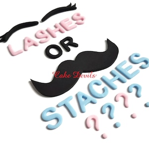 May include: Pink and blue cake topper with the text "Lashes or Staches?" and a black mustache and eyelashes.