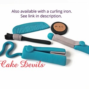 May include: A set of blue and grey cake decorations for a hair stylist or makeup artist. The set includes a comb, a makeup brush, a curling iron, a straightener, and a compact with the letters "M.A.C." on it. The text "Cake Devils" is also visible in the image.