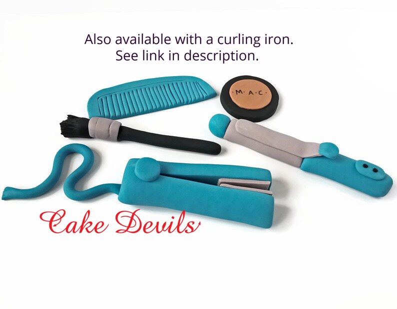 May include: A set of blue and grey cake decorations for a hair stylist or makeup artist. The set includes a comb, a makeup brush, a curling iron, a straightener, and a compact with the letters "M.A.C." on it. The text "Cake Devils" is also visible in the image.