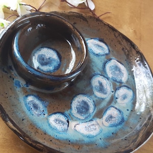 Handmade Pottery Swirled Chip & Dip with Lead-Free Frozen Pond Effect Glaze. Measures 9&quot; x 2&quot;. Colors include browns, blues and whites.