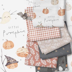 May include: A set of fabric swatches featuring various Halloween-themed patterns. The patterns include a gingham check, a floral design, a leafy pattern, a starry sky, and a pattern with ghosts and pumpkins. The text "Little Pumpkin" is written on one of the swatches.