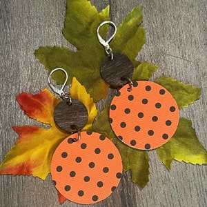 May include: A set of three ceramic mugs with a speckled, matte finish. The mugs are in shades of cream, light gray, and dark gray. Each mug has a simple, minimalist design and a rounded handle.