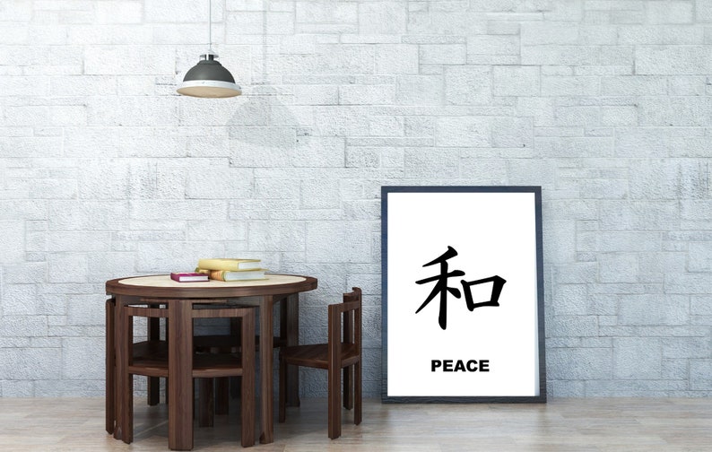 May include: A framed print with the Japanese character for peace, "和", and the word "PEACE" underneath. The print is hanging on a white brick wall above a round wooden table with four chairs.