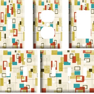 May include: Set of five light switch and outlet covers with a mid-century modern design. The covers feature a cream background with a pattern of red, teal, yellow, and black geometric shapes and lines. The covers are for a variety of electrical outlets.