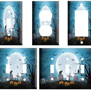 May include: Four different Halloween themed light switch covers. Each cover features a blue background with a full moon, a spooky tree, and a black cat. The covers are decorated with tombstones, pumpkins, and bats. The switch covers are available in single-pole, double-pole, and three-way configurations.