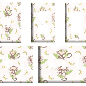 May include: Four light switch covers with a white background and a pattern of monkeys wearing flower crowns and holding bananas. The monkeys are brown and the bananas are yellow. The pattern is repeated on each cover.